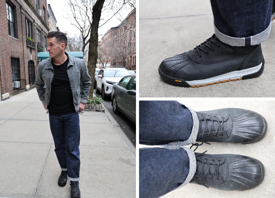 Nick wearing a slate grey coat, black t shirt, dark selvedge denim jeans, and black Allweather duck boots.