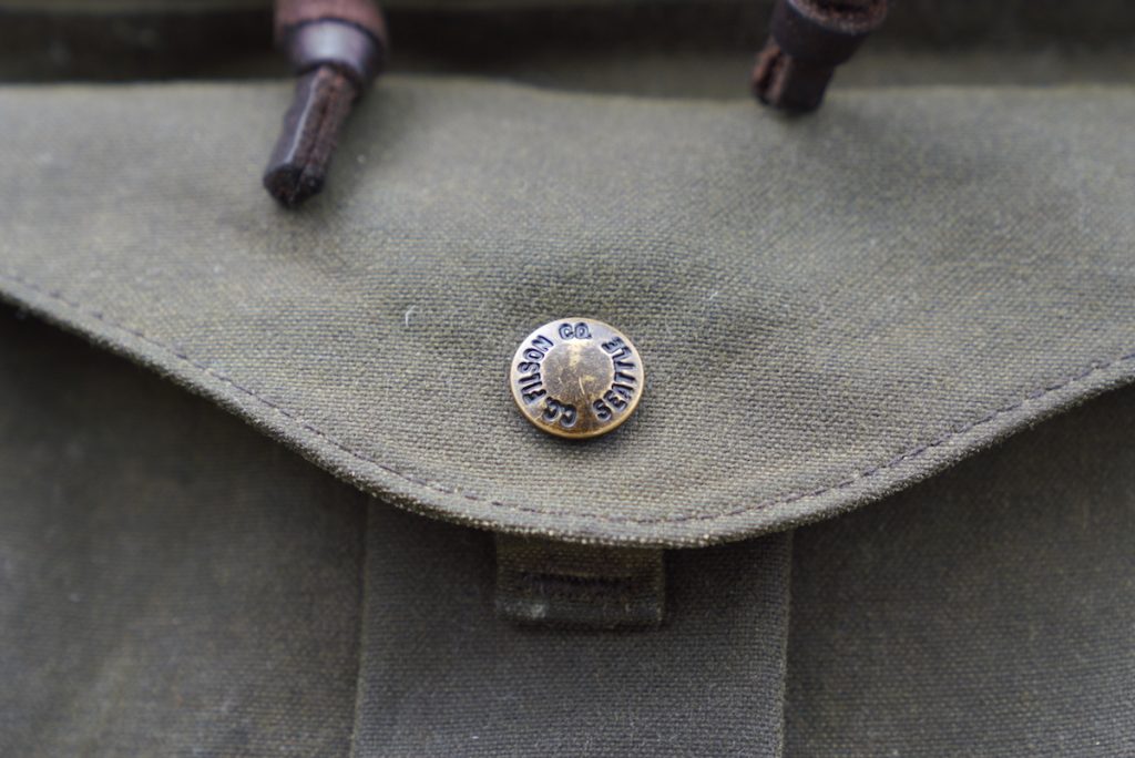 filson journeyman backpack button clasp