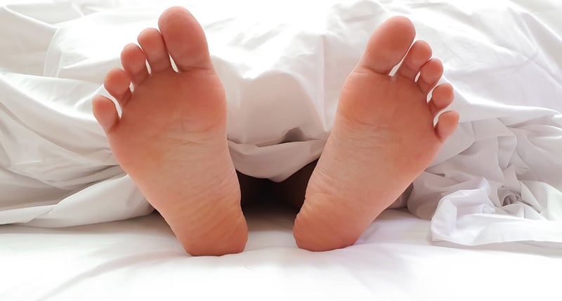womens feet in bed