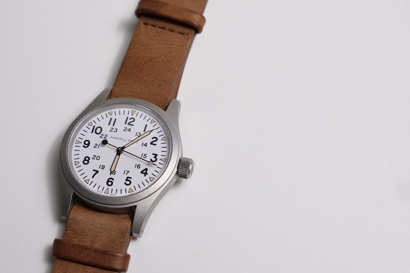 hamilton khaki field watch on tabletop