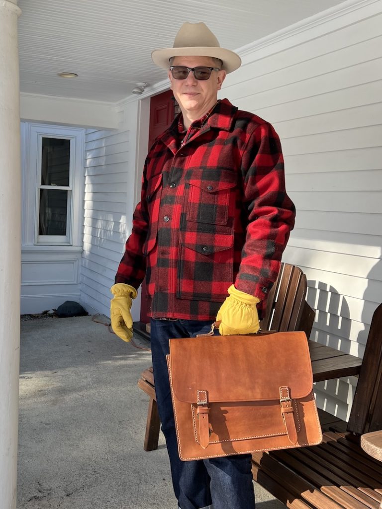 linden leather messenger bag in hand