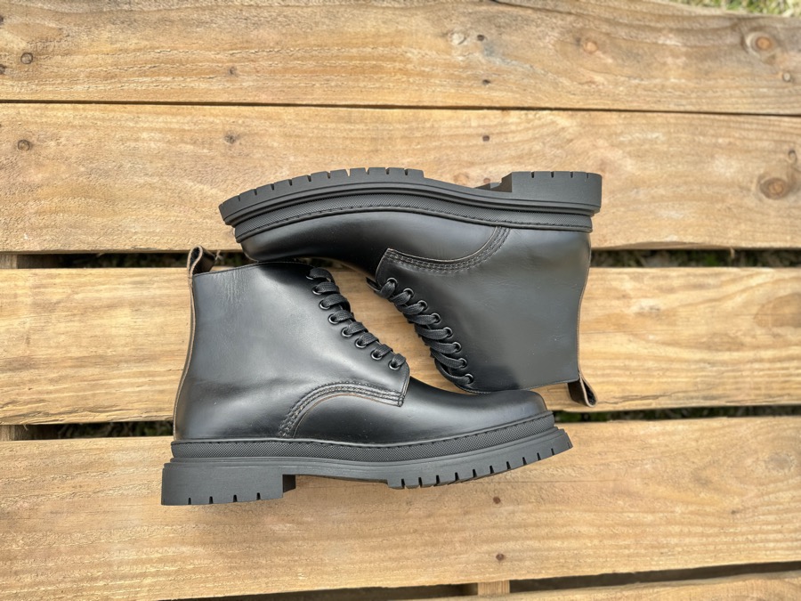 Black Horween leather Goral Sharman boots profile on wood pallet