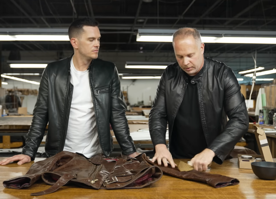 two men cleaning a leather jacket with Otter Wax Saddle Soap