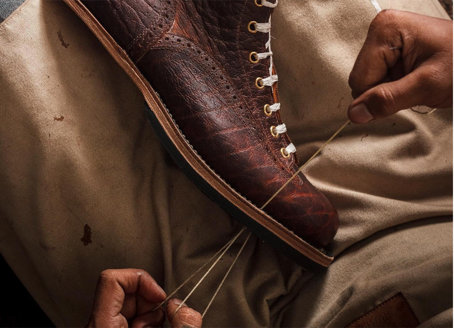 An artisan from Sagara boots hand stitching and hand welting a pair of boots