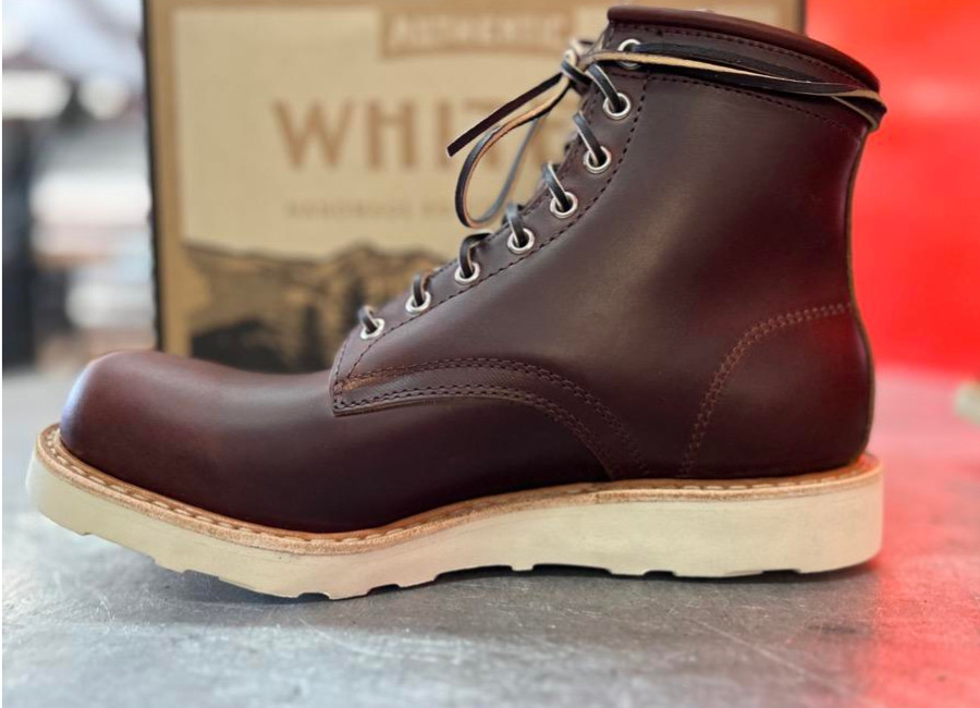White's the Springdale, a round toed boot with a white wedge sole, oily leather, and leather laces.