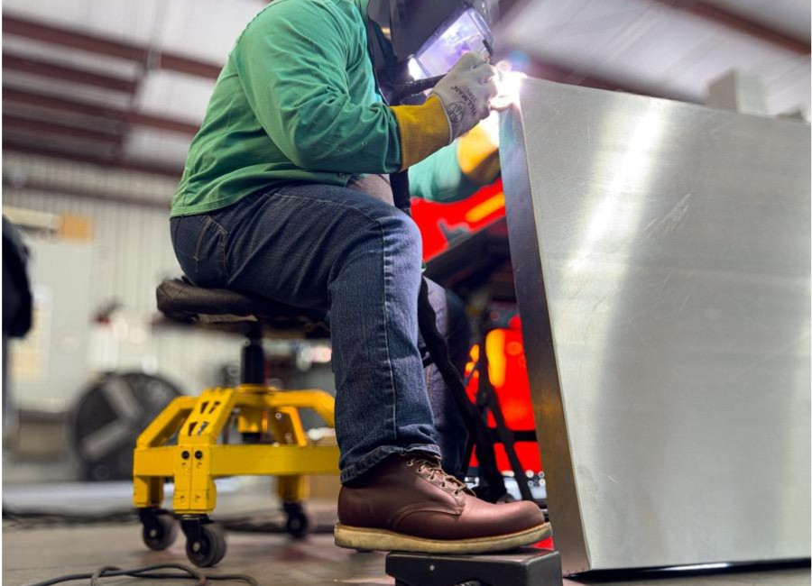 A man sheet welding in White's the Springdale wedge soled boot