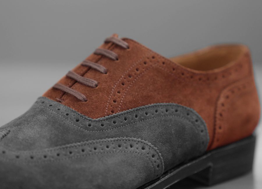 An oxford shoe, we've highlighted the vamp, or top part of the shoe to show the dressier closed lacing system. It's simpler looking.