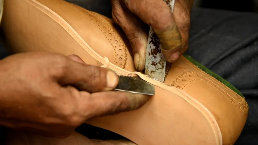 Edge trimming a boot at blkbrd factory